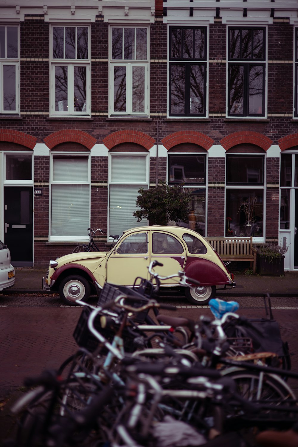 yellow and black motorcycle parked beside white and brown concrete building