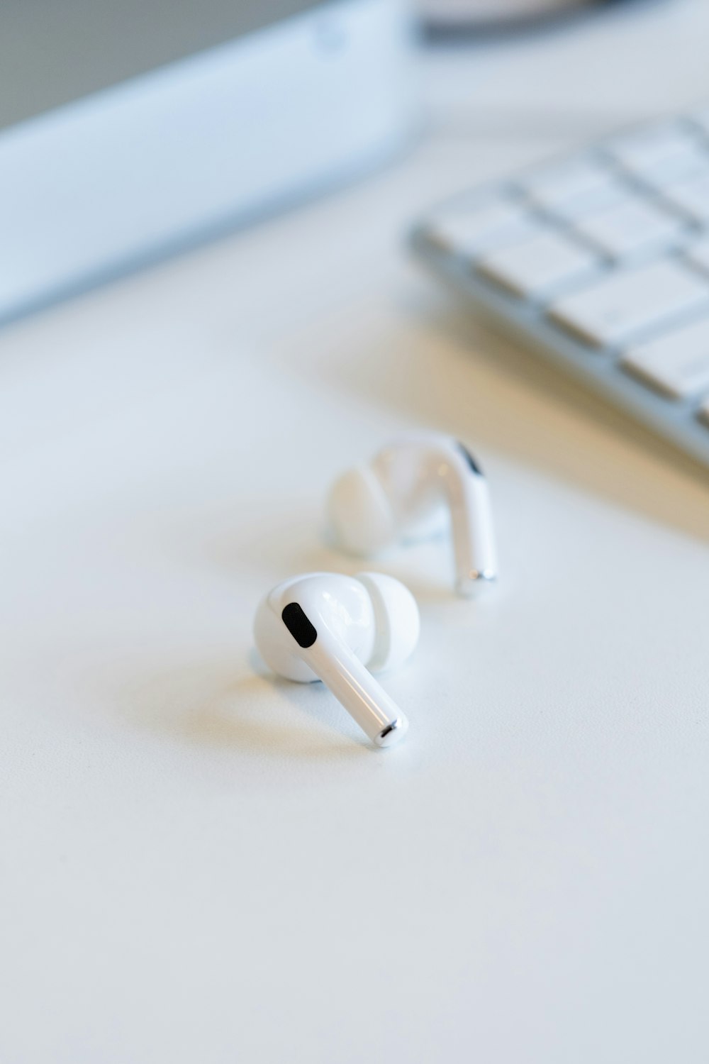 white apple earpods on white table