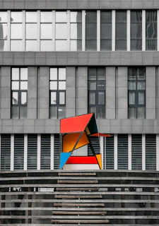 A modern art piece with bold colors and dynamic shapes, contrasting with classic works nearby.