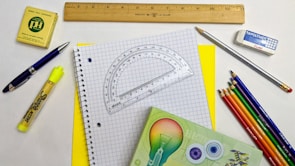 A vibrant display of various stationery items including markers, erasers, and rulers.