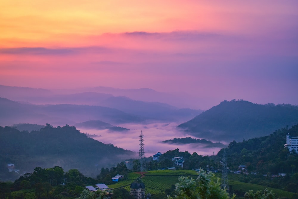 green trees and mountains during sunset