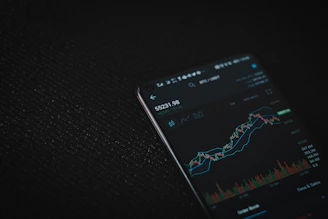 black android smartphone on black textile