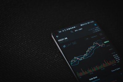 black android smartphone on black textile