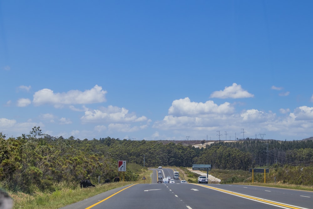 gray car on road under blue sky during daytime