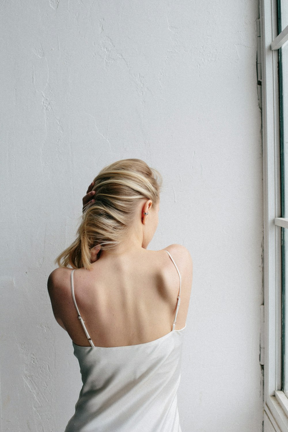 woman in white spaghetti strap top