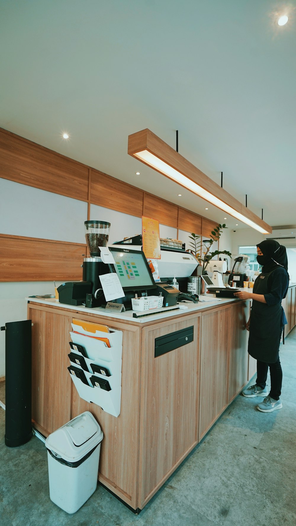 man in black shirt standing near brown wooden counter