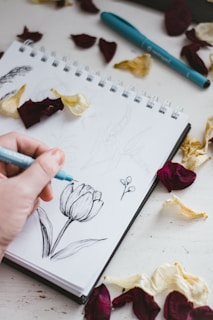 person holding purple and white coloring book
