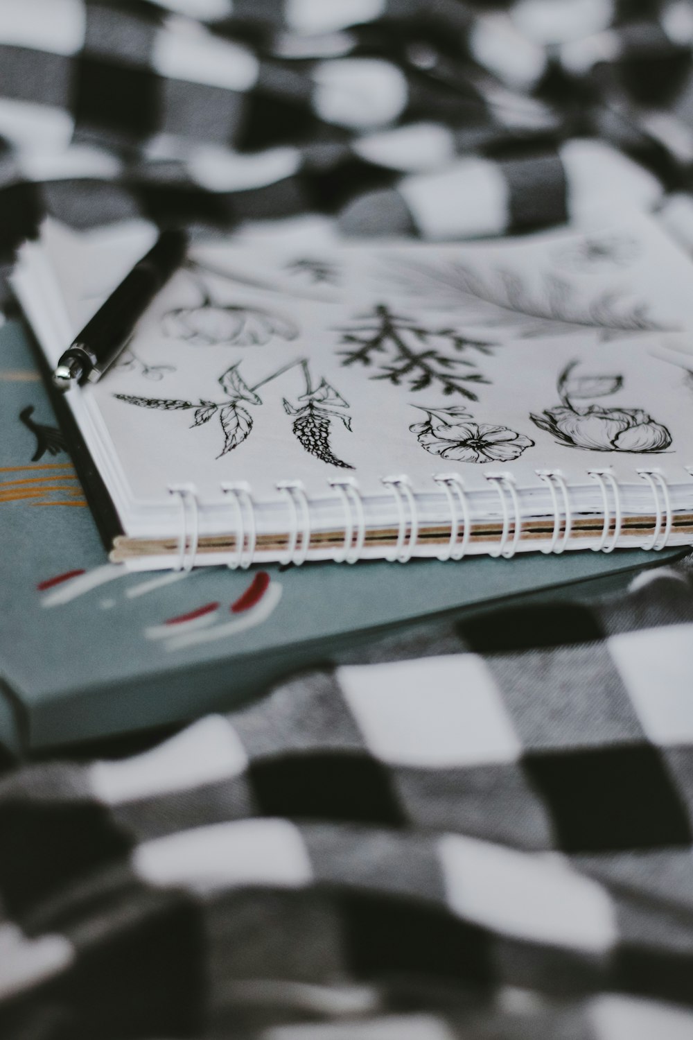 white and black book on white and black checkered textile