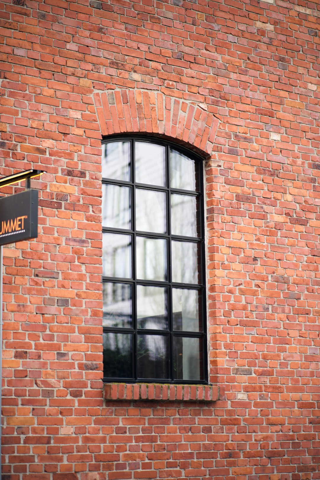 brown brick building with glass window