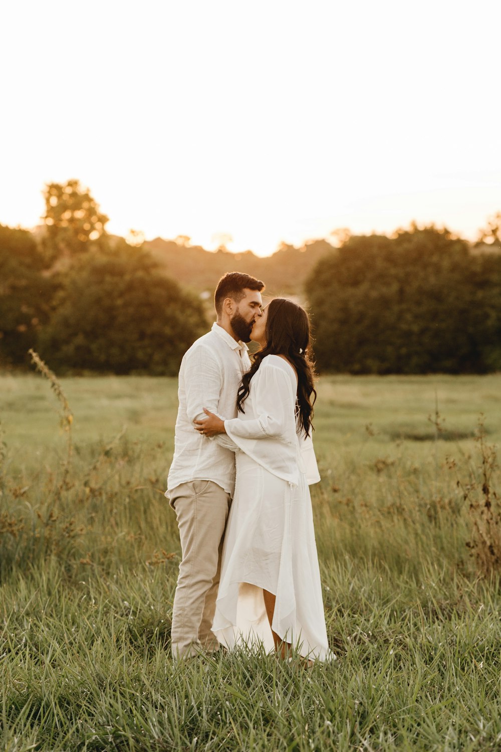 man and woman standing on green grass field during daytime