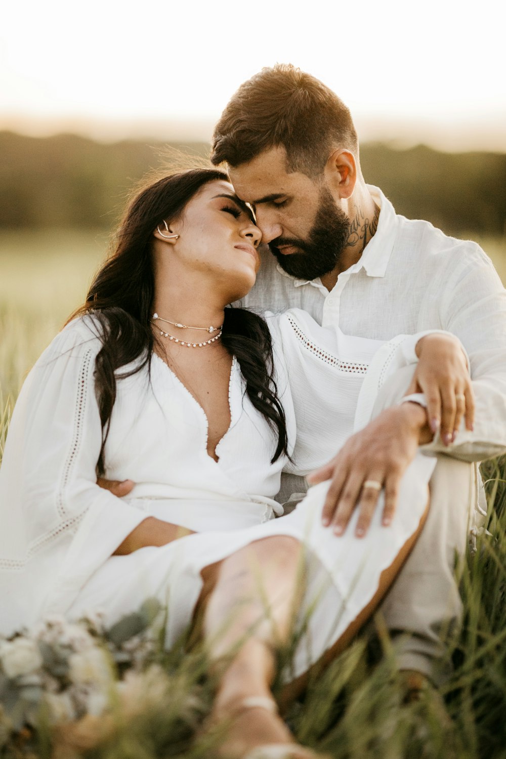 man in white dress shirt kissing woman in white dress