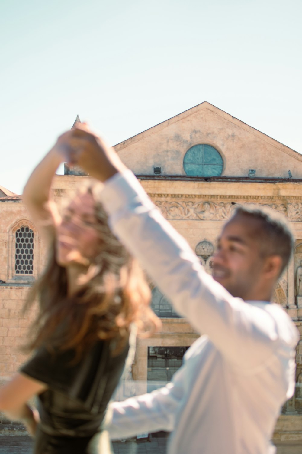 man in white long sleeve shirt holding girl in white long sleeve shirt during daytime