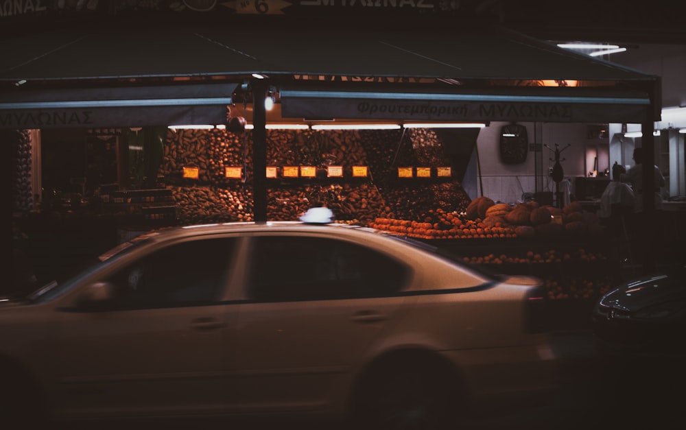 white sedan parked near building during night time