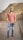 man in red and white plaid dress shirt and blue denim jeans standing on road during