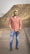 man in red and white plaid dress shirt and blue denim jeans standing on road during