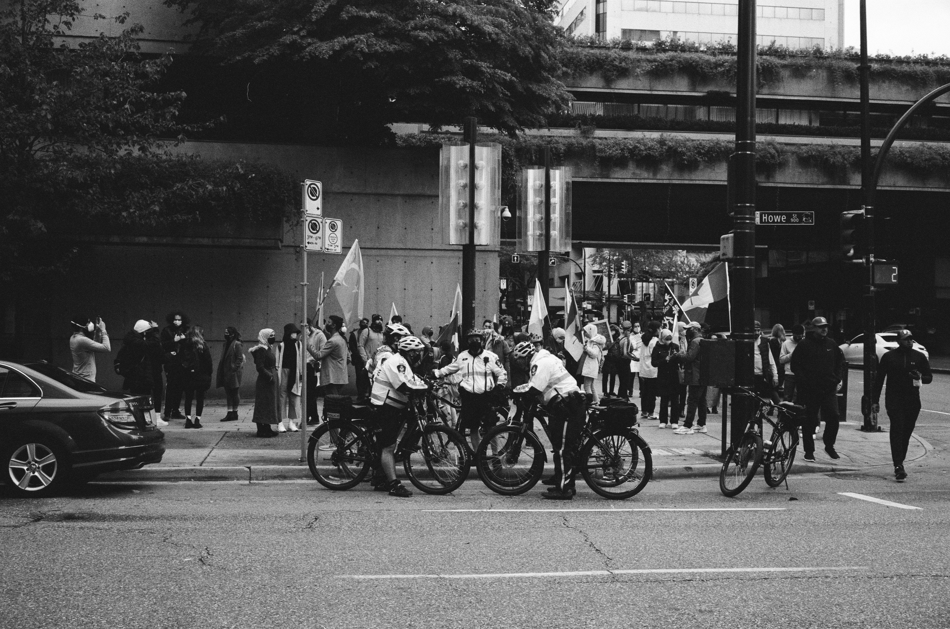 grayscale photo of people riding motorcycle on road