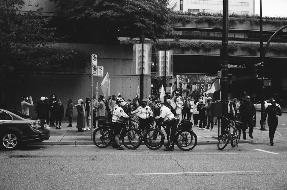 grayscale photo of people riding motorcycle on road