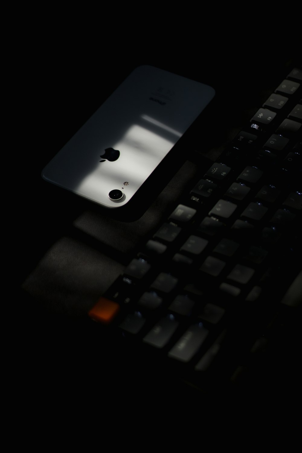 white iphone 4 on black computer keyboard
