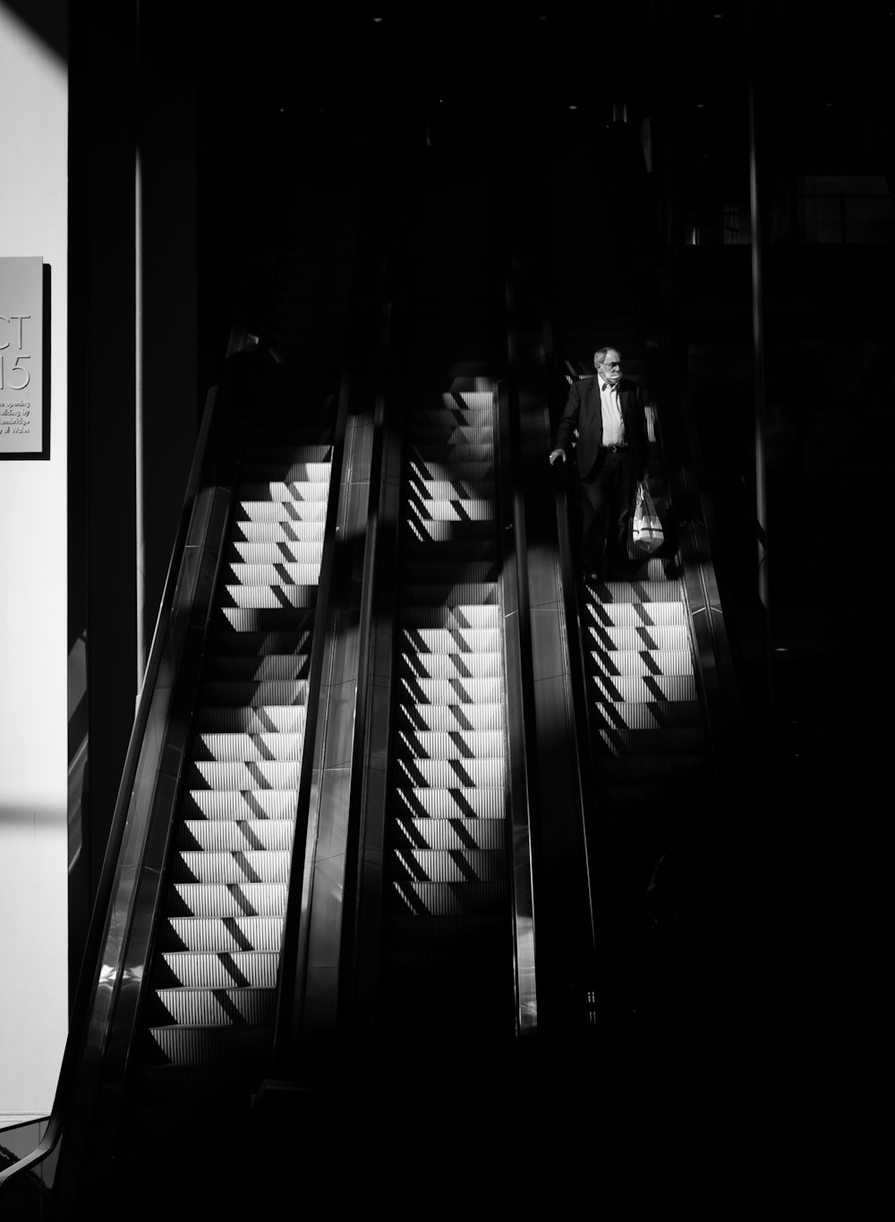 grayscale photo of woman sitting on staircase