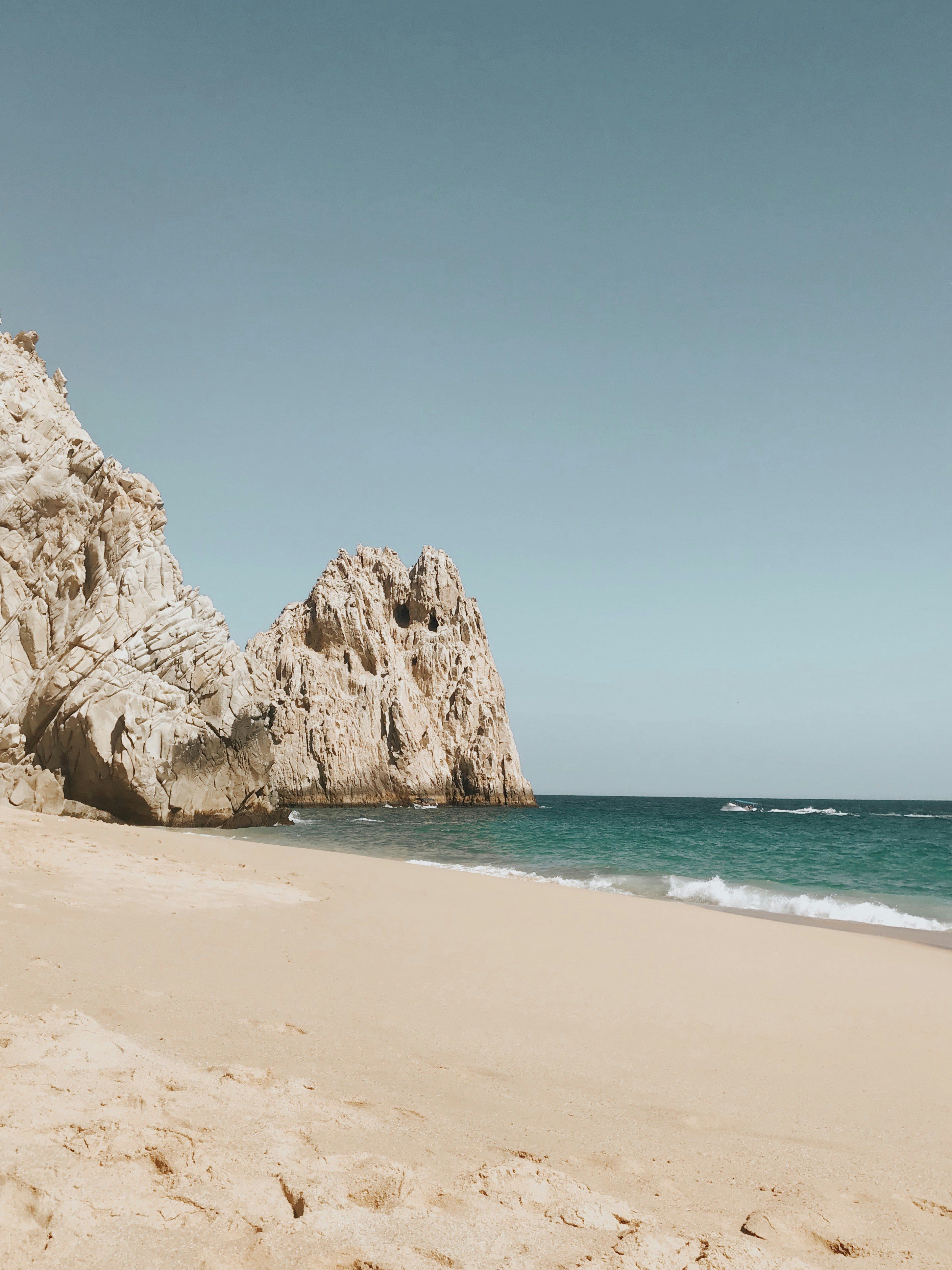 brown rock formation on sea shore during daytime