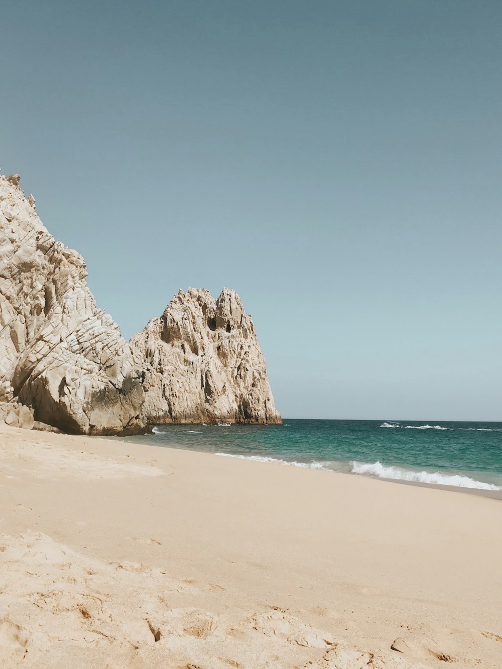 brown rock formation on sea shore during daytime