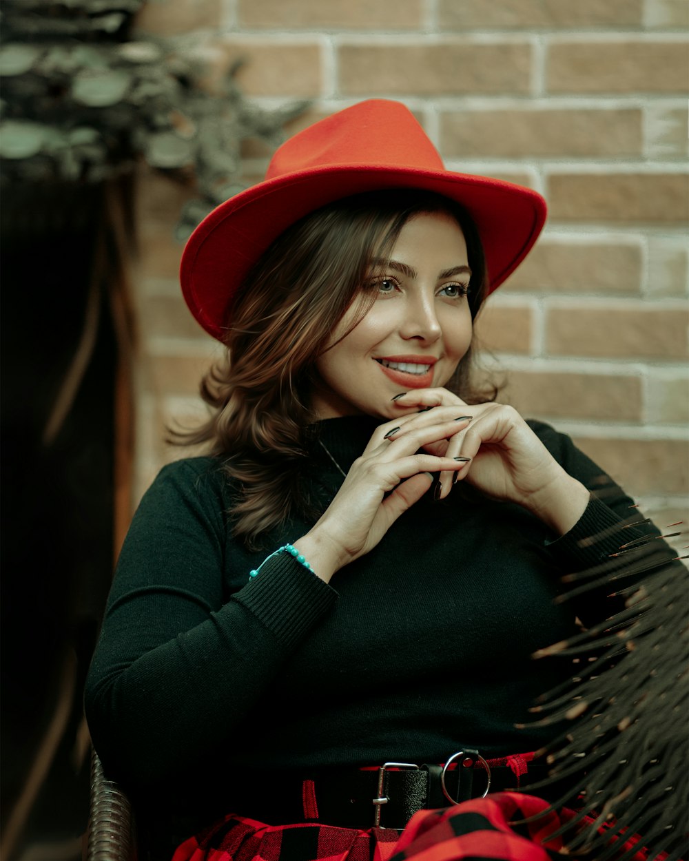 woman in black long sleeve shirt wearing red hat
