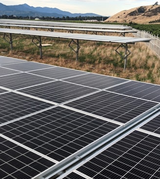 black solar panel on green grass field during daytime