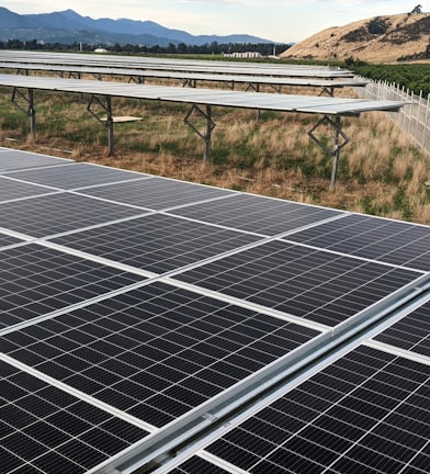 black solar panel on green grass field during daytime