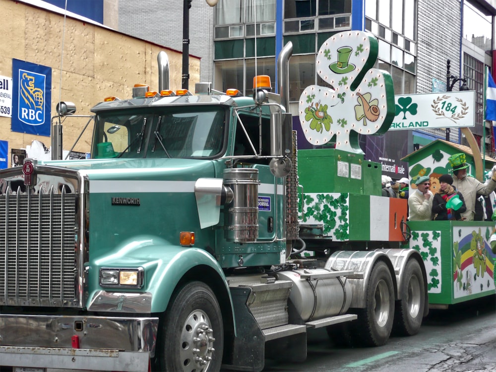 green and white truck on trailer truck