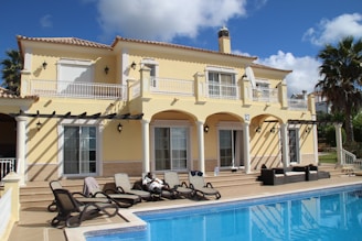 white and black motorcycle parked beside white concrete building during daytime