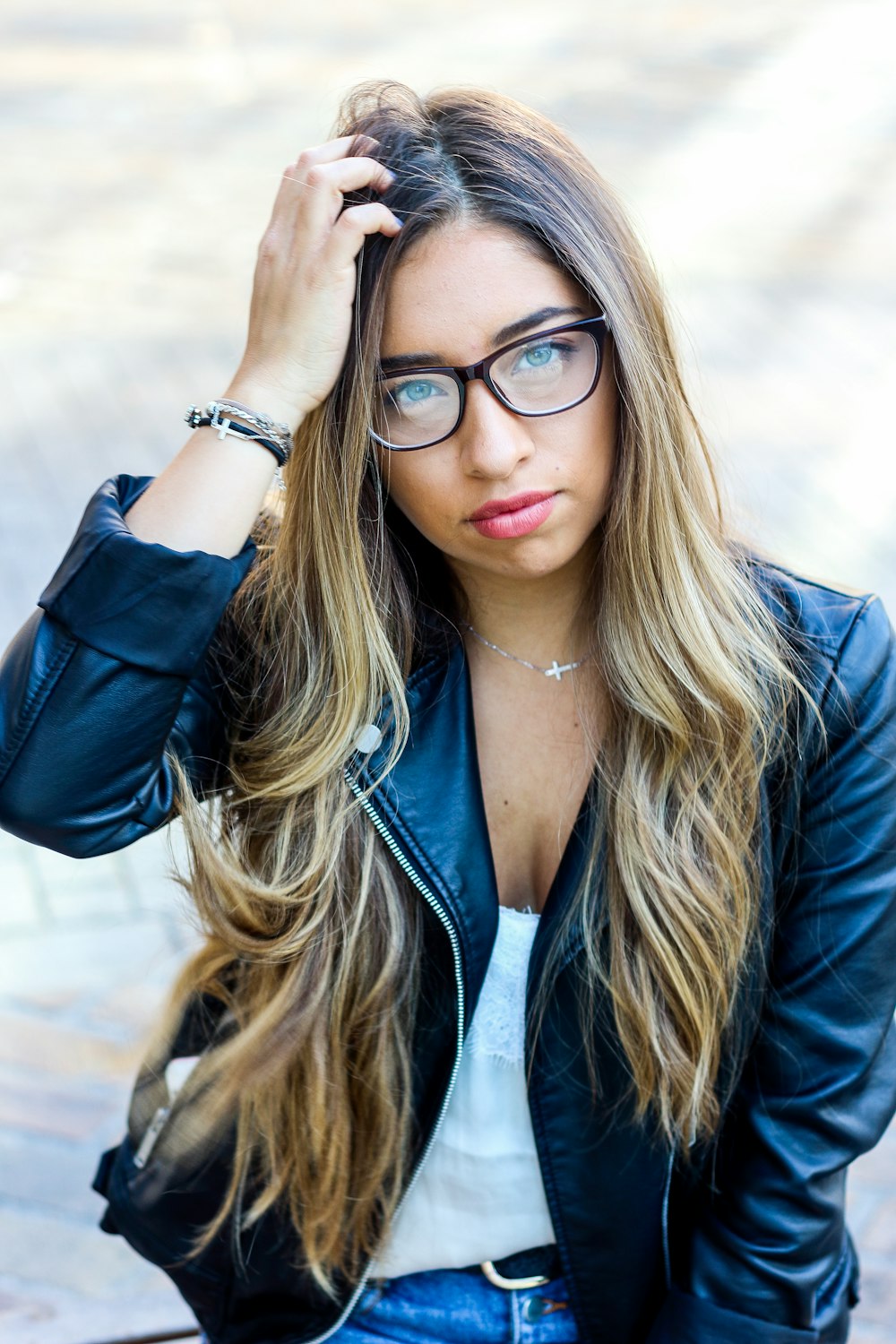 woman in black leather jacket wearing black framed eyeglasses