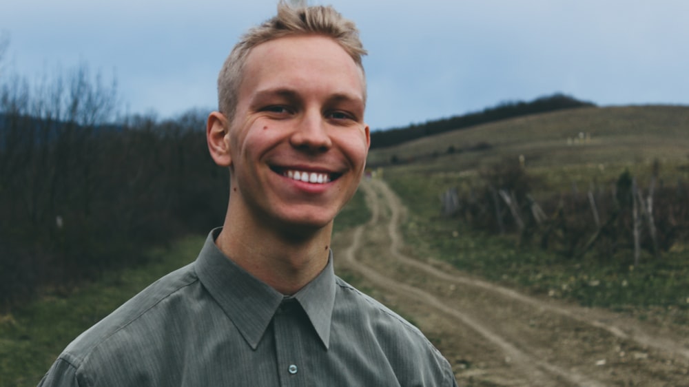 man in gray button up shirt smiling