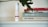 A white bottle with the label 'LUFF CBD Cream Assist' is placed next to a stack of books. The books have titles related to 'Surf Shacks'. A large, dark green leaf partially covers the top of the books.