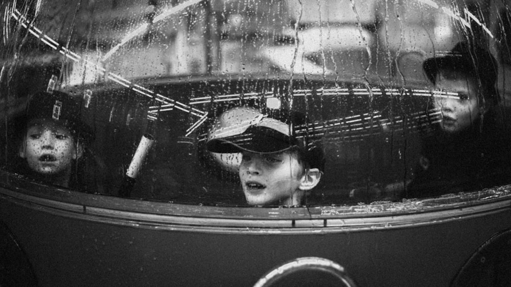 grayscale photo of man in black hat