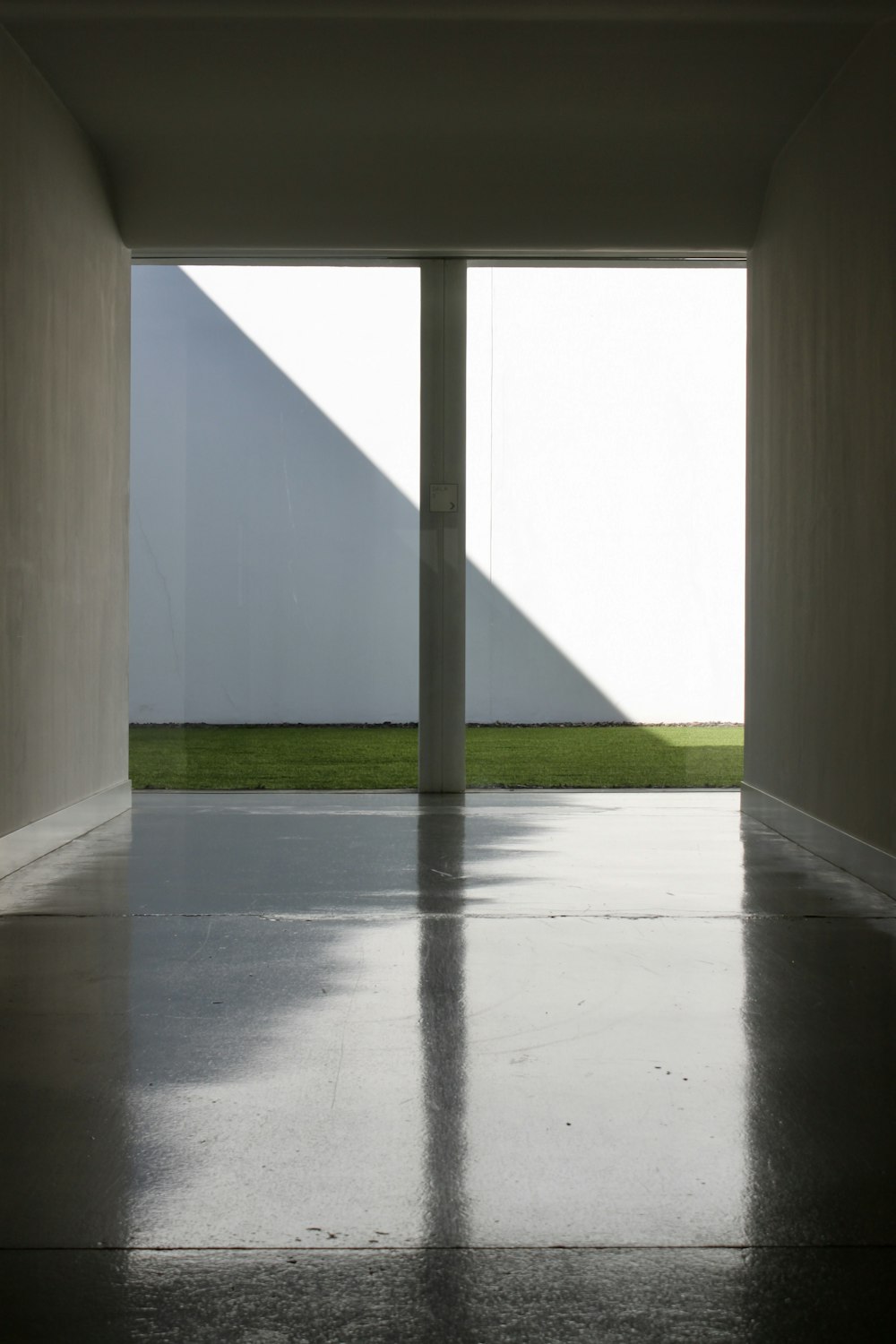 white concrete building with green grass field