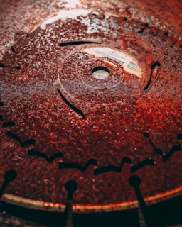 Close-up of a boron steel rotavator blade gleaming under natural light, highlighting its sharp edge and robust build.