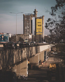 cars on road near bridge during daytime