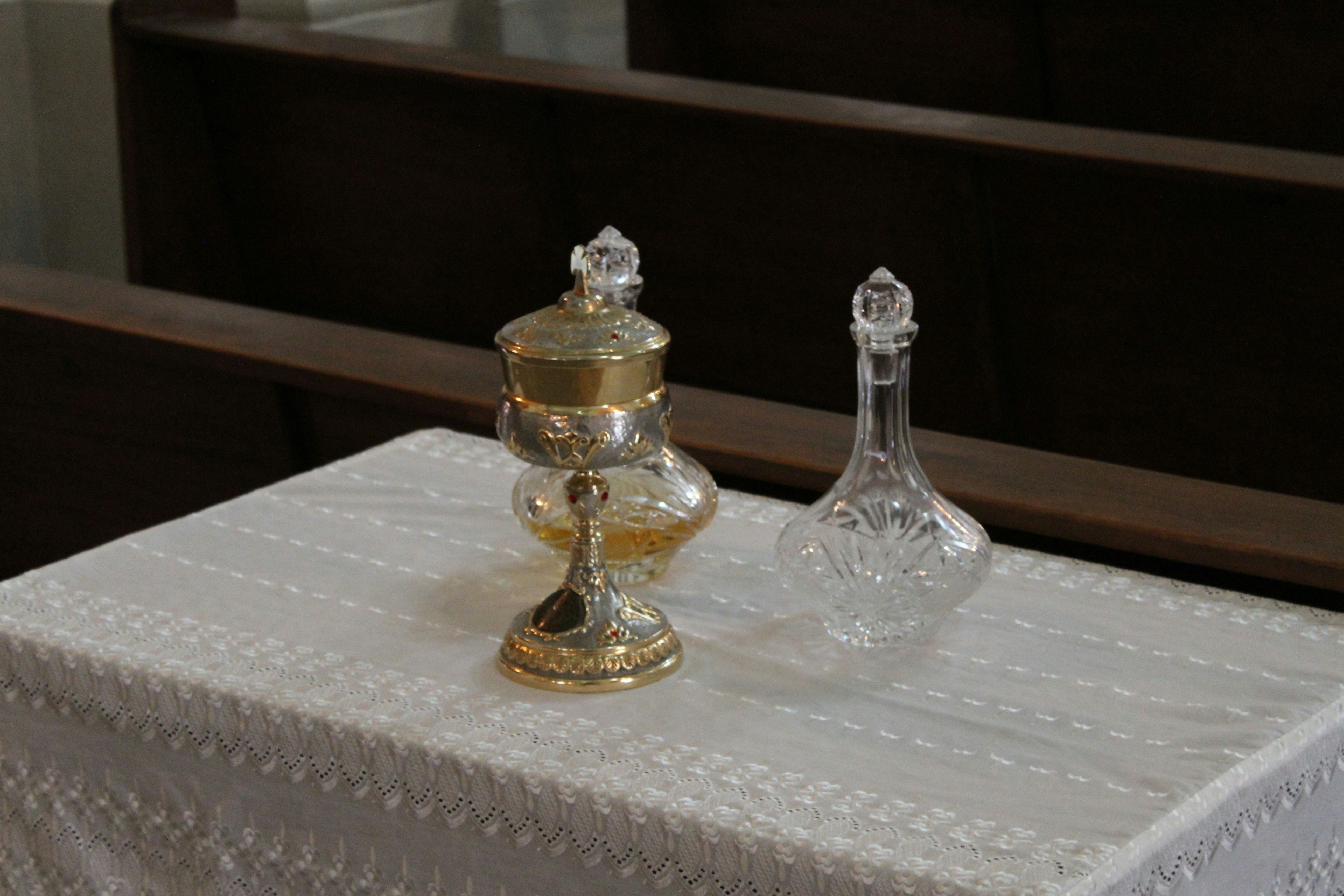 gold and silver glass chess piece on white table cloth