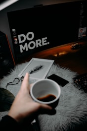 person holding white ceramic mug