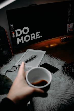 person holding white ceramic mug