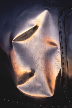 Close-up of a metal surface with a glossy industrial coating reflecting light.