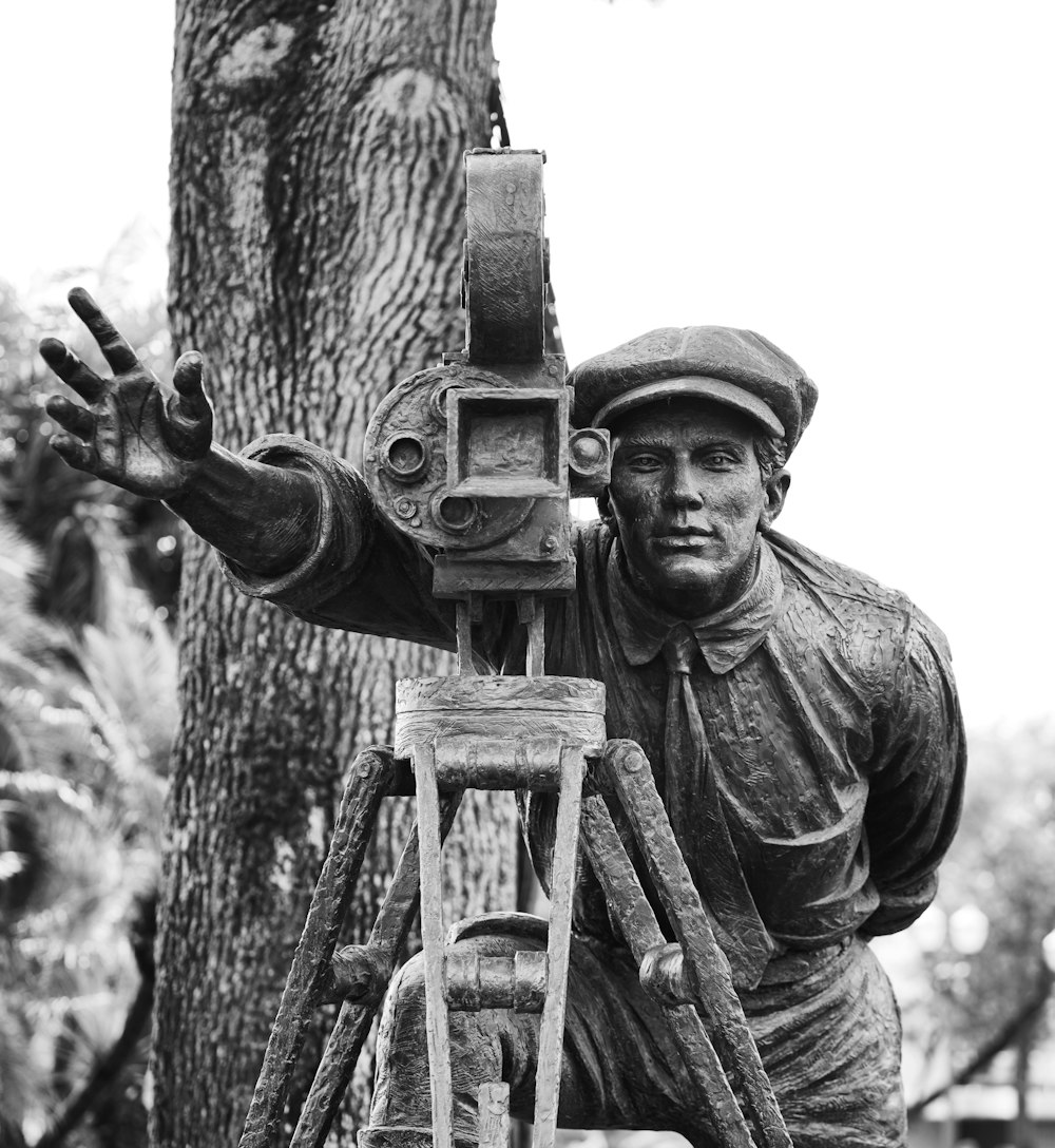 man in black long sleeve shirt holding a black and gray camera