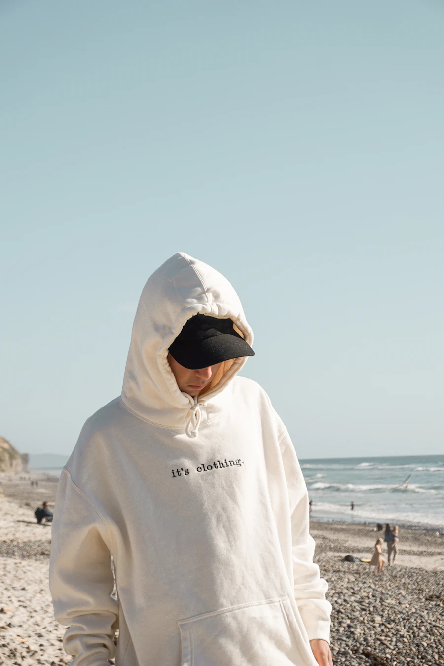 Double-layer hood worn up on a beach