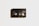 A vintage black Sony MP90 8mm video cassette is centered against a light background. It has visible spools through a transparent window and displays the text 'Sony', 'MP90', and 'PAL 8'. A subtle shadow casts to the left, adding depth.