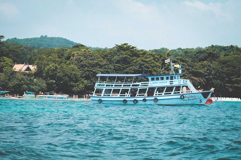 white boat on body of water during daytime