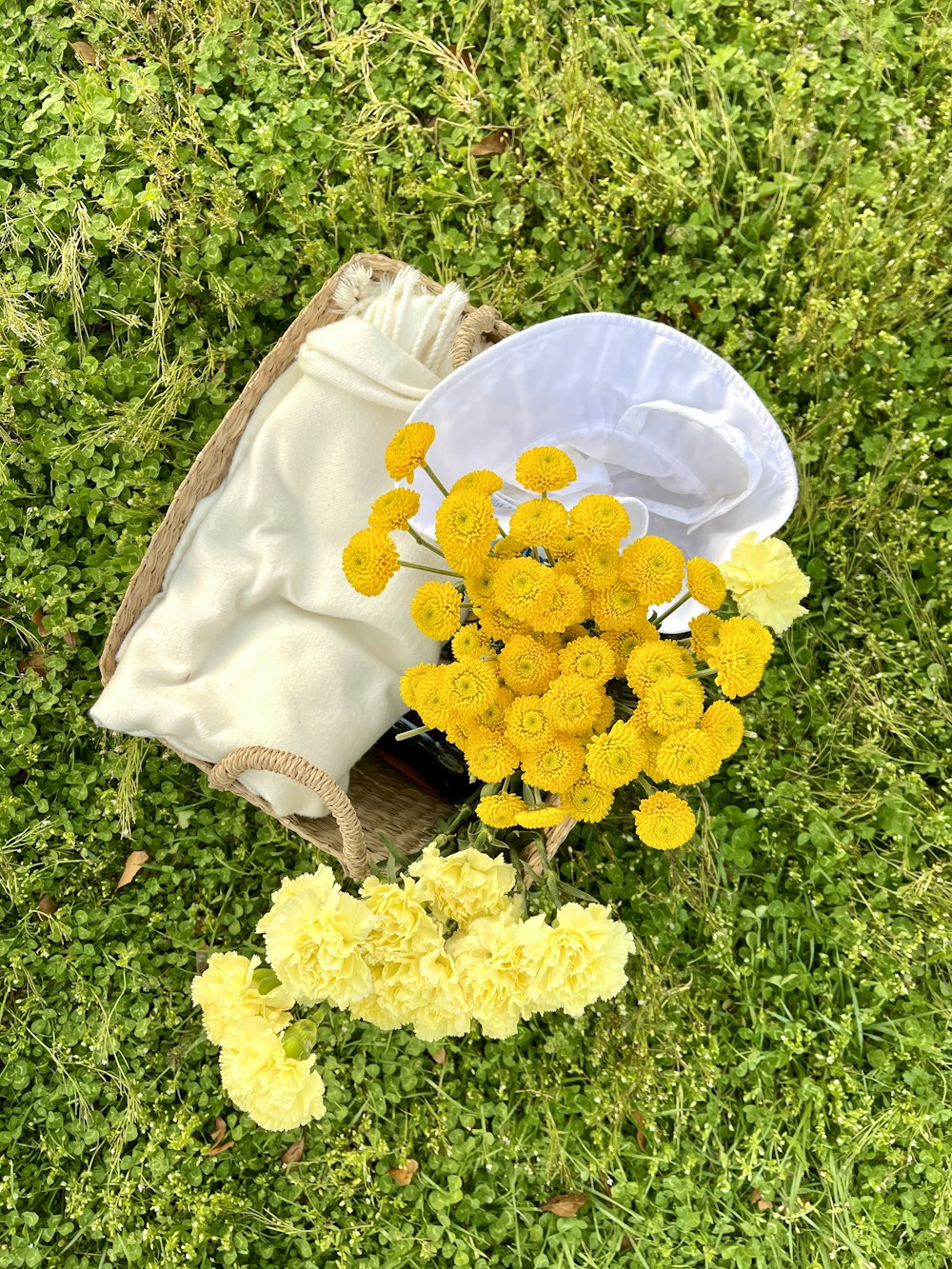 flores amarillas en bolsa de cuero marrón en campo de hierba verde durante el día