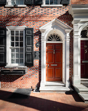 brown brick building with black wooden door