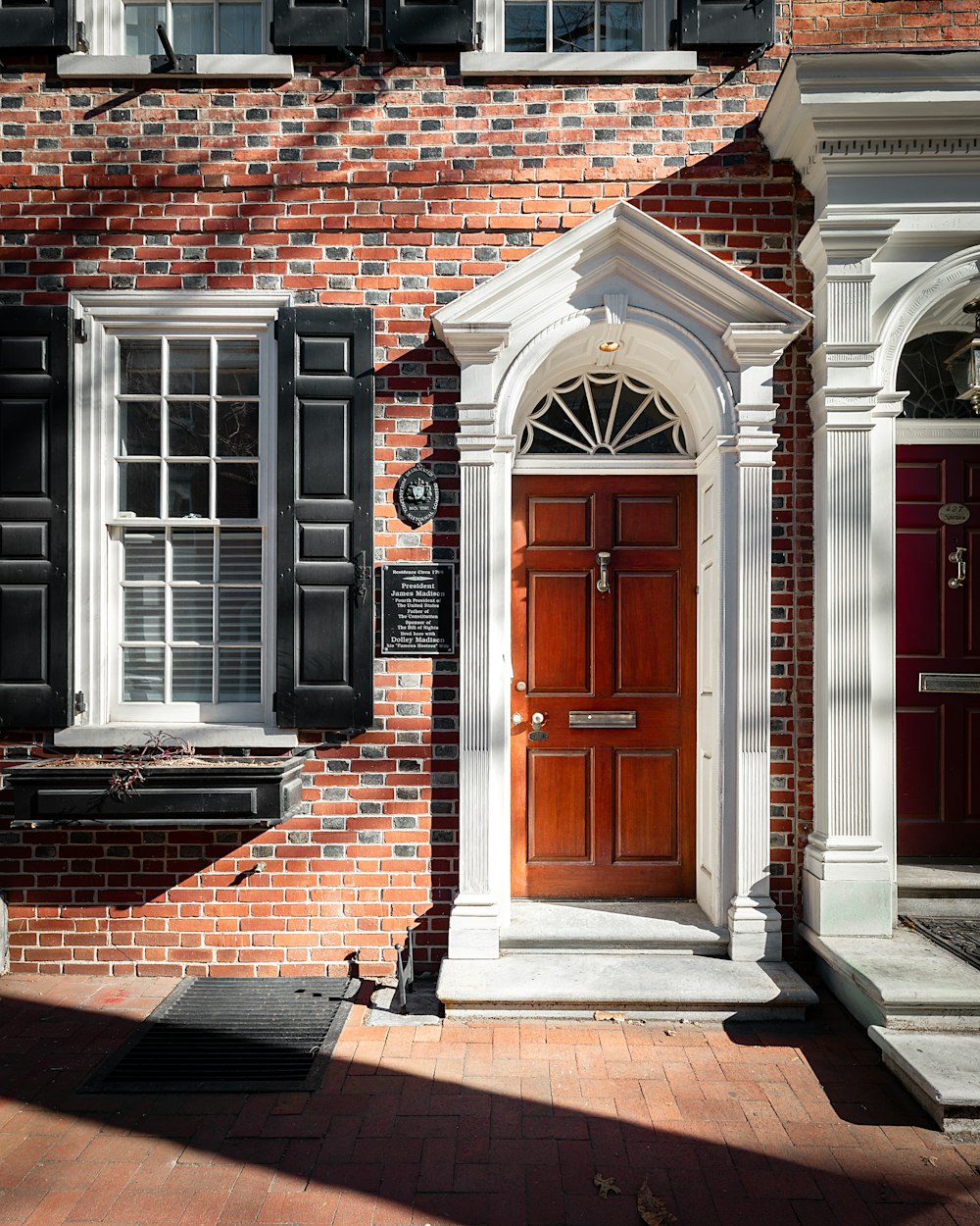 brown brick building with black wooden door