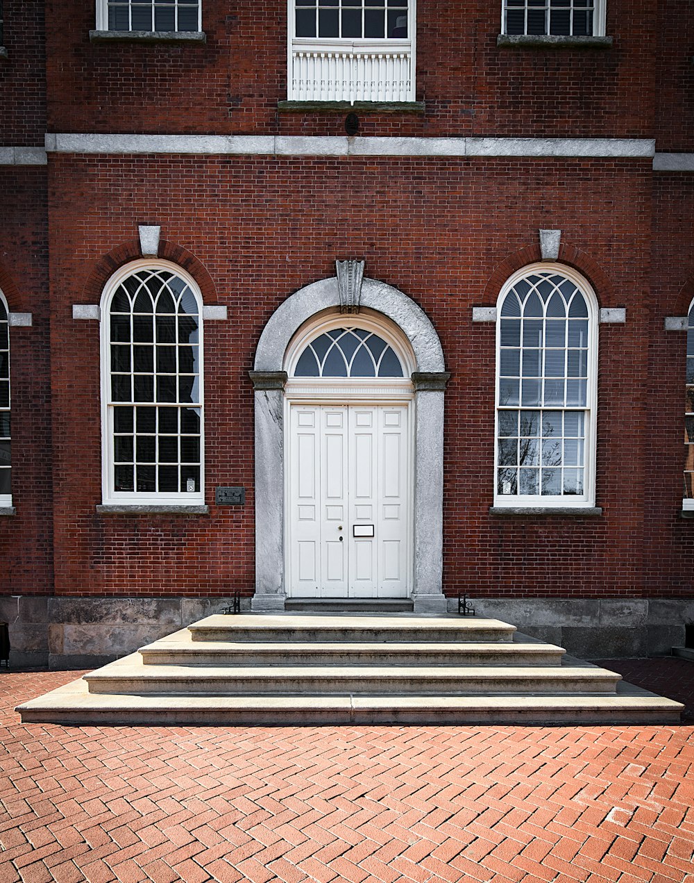 brown brick building with white wooden door