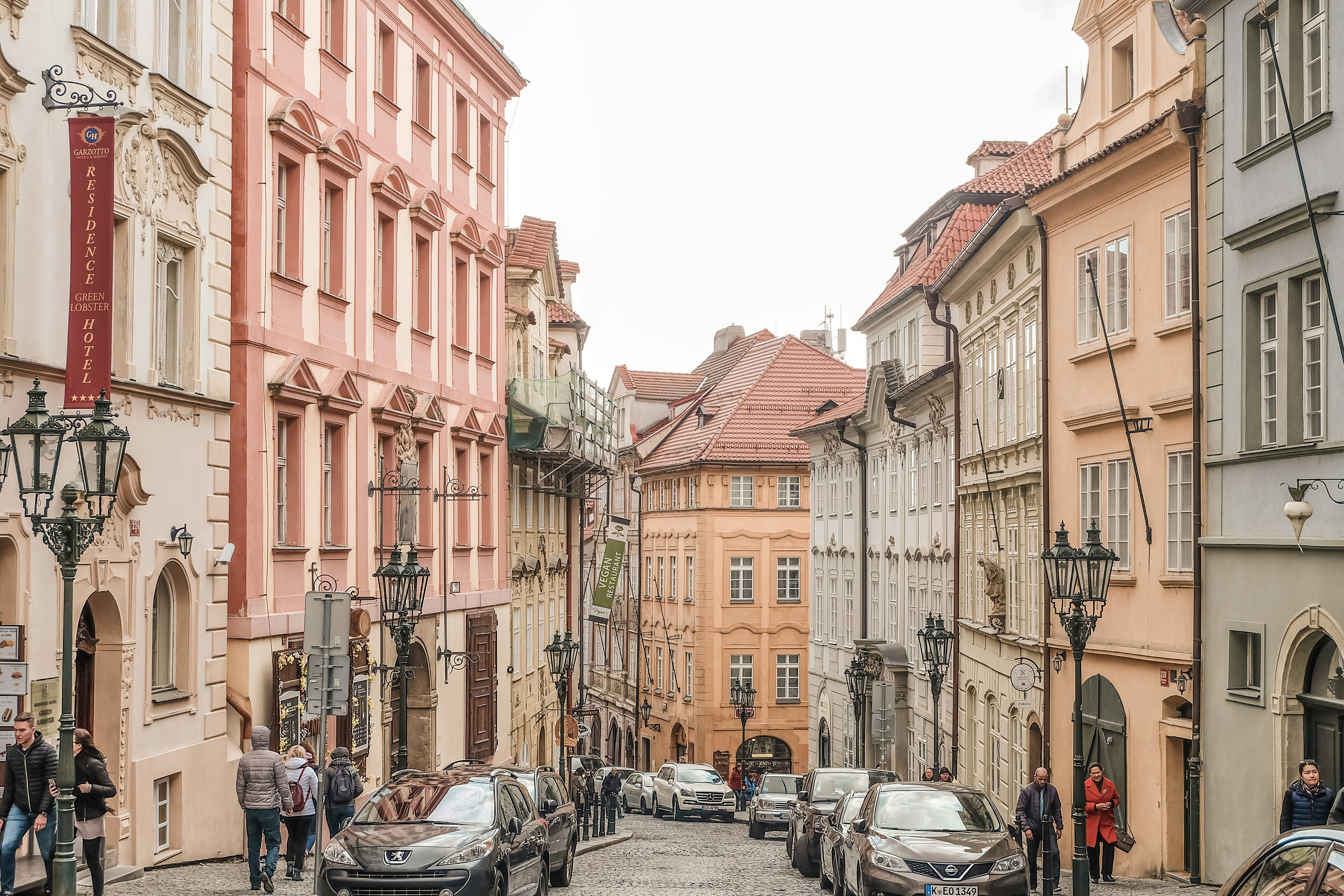 cars parked beside brown concrete building during daytime